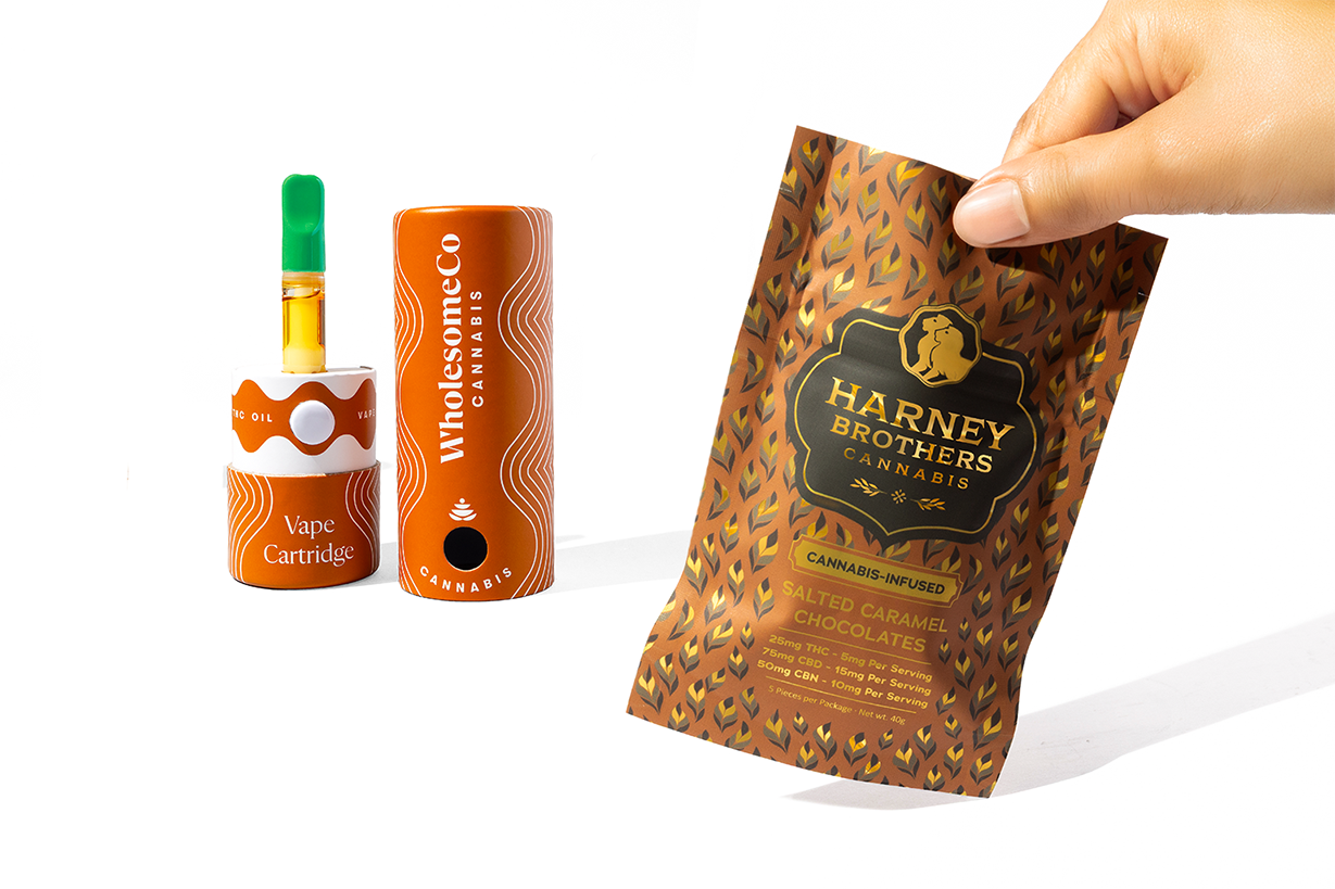 Hand reaching for a tilted Harney Brothers Dymapak Secure Sack with Child-Resistant paperboard tubes in background